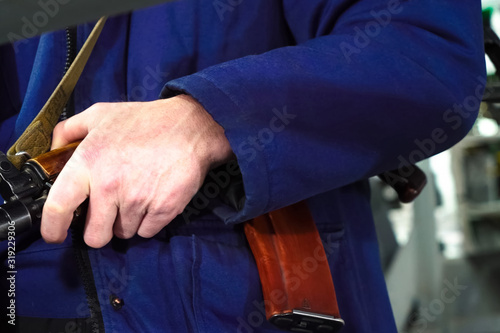 A security guards hand on a Kalashnikov. Armed departmental guards.