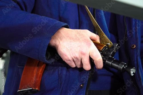 A security guards hand on a Kalashnikov. Armed departmental guards.