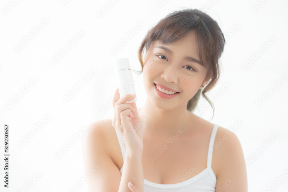 Beautiful portrait young asian woman holding and presenting cream or lotion product, beauty asia girl show cosmetic makeup and moisturizing for skin care, healthy care and wellness concept. Beautiful portrait young asian woman holding and presenting cream or lotion product, beauty asia girl show cosmetic makeup and moisturizing for skin care, healthy care and wellness concept.