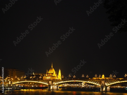 A beautiful night panorama of Budapest the capital of Hungary with Danube river and illuminated bridge and Parliament in summer