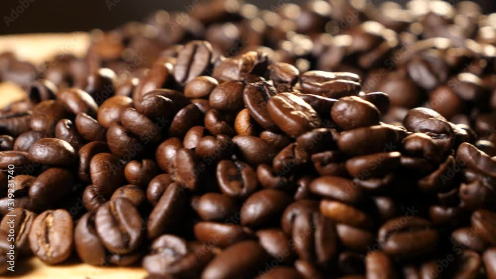 A handful of coffee beans. Panorama from left to right. Coffee on a wooden board. Coffee beans. Coffee. Close-up. A handful of coffee beans. Panorama from left to right. Coffee on a wooden board. Coffee beans. Coffee. Close-up.