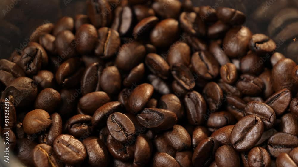 Coffee beans are falling down. Coffee in the can. Coffee beans. Coffee. Drink. Close-up.
