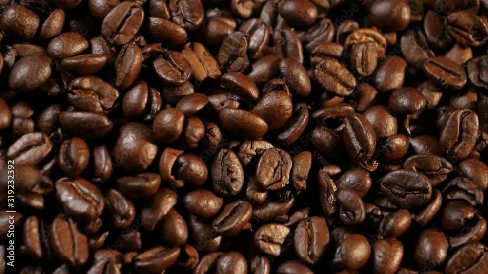Coffee beans. Coffee. Drink. Beautiful grains. Making coffee. Coffee beans are lying. Warm light. Grains fall in a heap. Close-up. Coffee beans. Coffee. Drink. Beautiful grains. Making coffee. Coffee beans are lying. Warm light. Grains fall in a heap. Close-up.