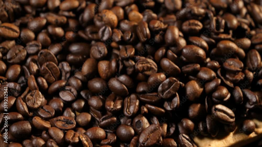 Coffee beans. Coffee. Drink. Beautiful grains. Making coffee. Coffee beans are lying. Warm light. Panorama from bottom to top. Close-up. Coffee beans. Coffee. Drink. Beautiful grains. Making coffee. Coffee beans are lying. Warm light. Panorama from bottom to top. Close-up.