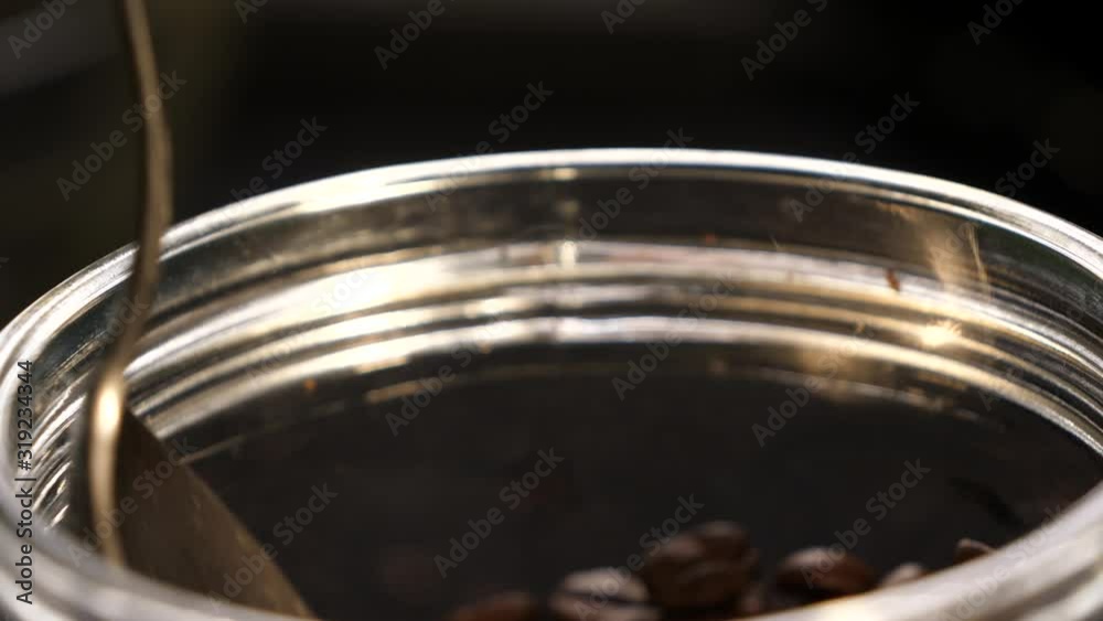 Spoon with coffee. Coffee in the can. Coffee beans. Coffee. Black background. Close-up. Spoon with coffee. Coffee in the can. Coffee beans. Coffee. Black background. Close-up.
