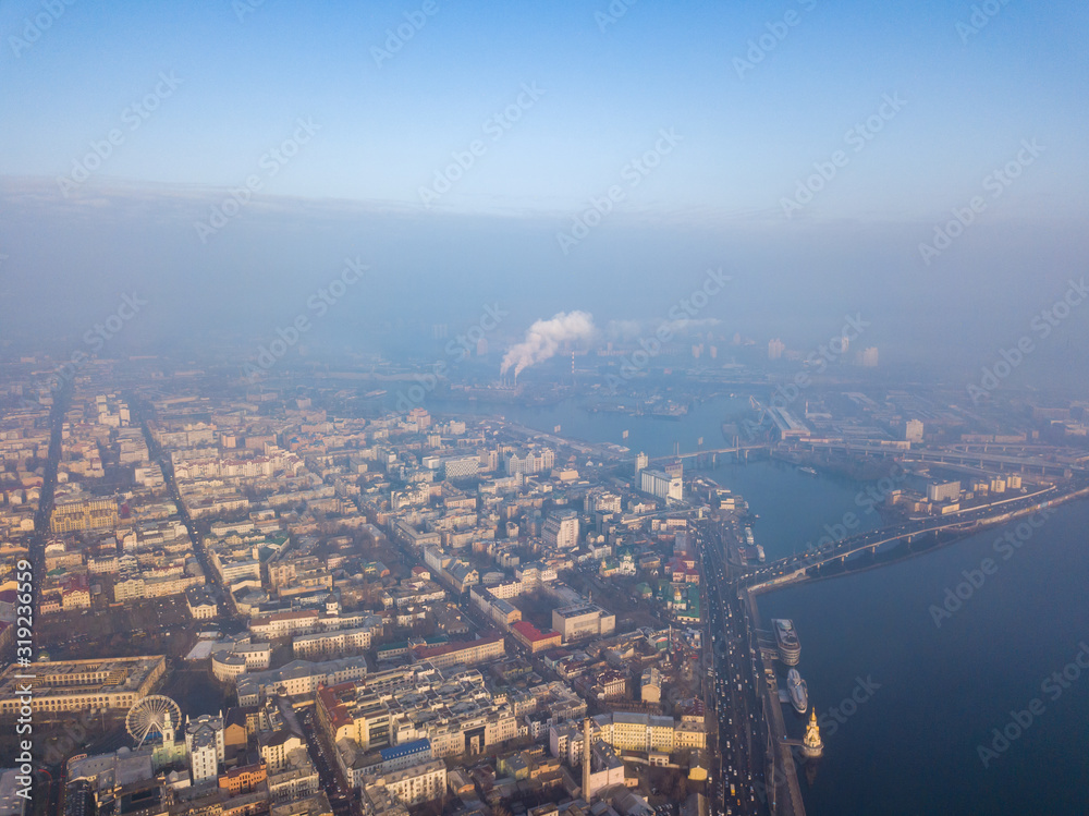 Aerial drone view. View of the historical part of Kiev and the Dnieper River on a foggy morning.