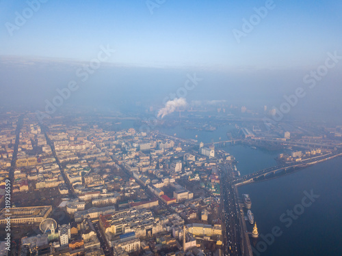 Aerial drone view. View of the historical part of Kiev and the Dnieper River on a foggy morning. © Sergey