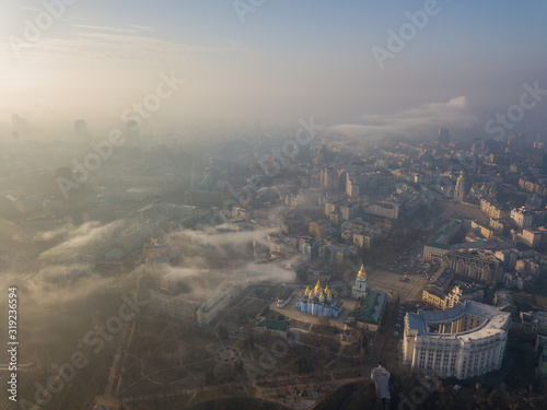 Aerial drone view. St. Michael's Cathedral among the city of Kiev on a foggy morning.