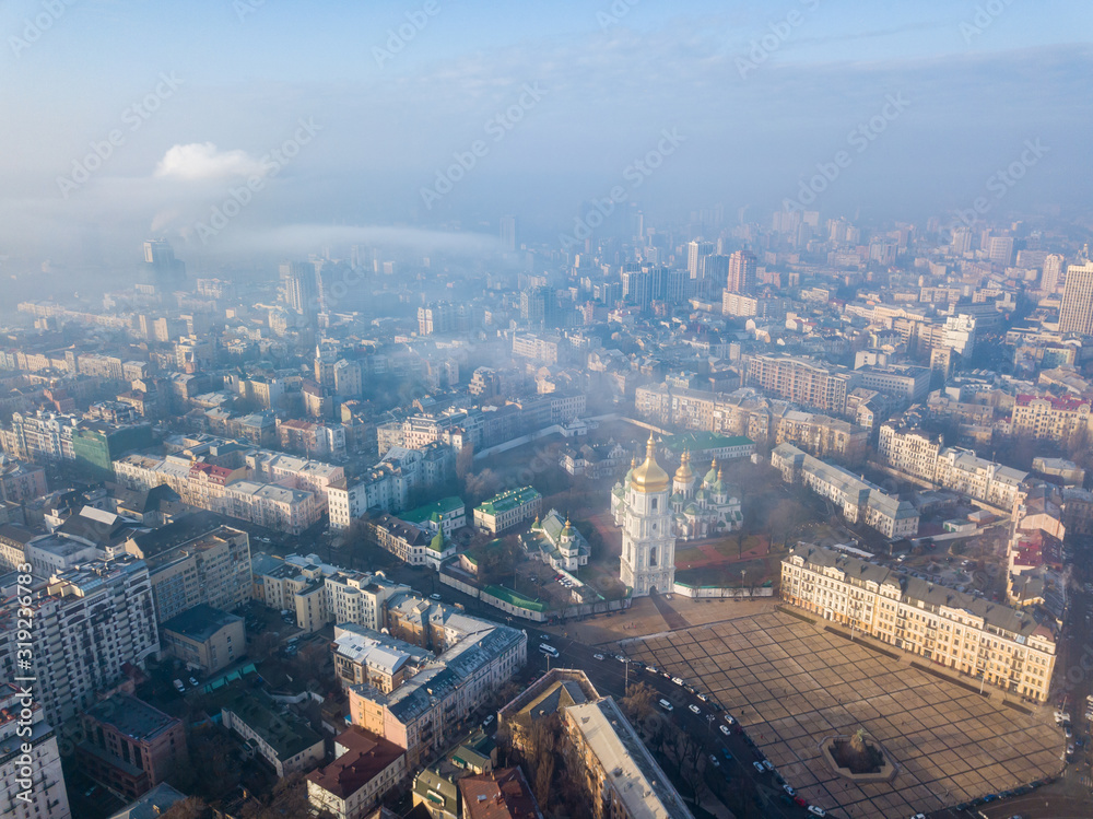 Aerial drone view. St. Sophia Church among the city of Kiev on a foggy morning.