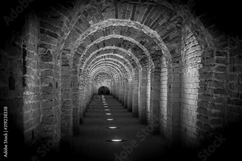 Brick tunnel archway made of red bricks as a passage between the two wings of a medieval castle. Granite stone an brick built Interior corridor way to bastions