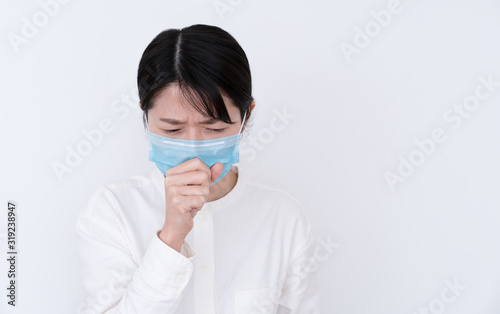  Young ill woman coughing on white background
