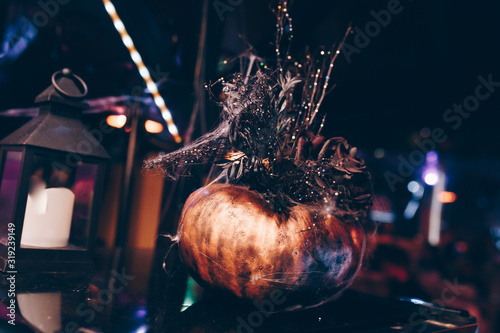 holidays image of halloween. Pumpkins over wooden table at night scary, near misty candle lanternlamp photo