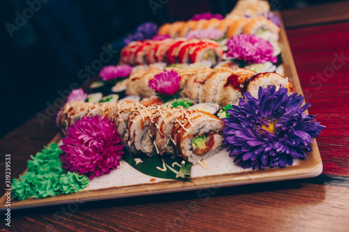 A large set of Delicious sushi rolls view from above Flat Lay . A lot assortment Philadelphia roll Dishes from Japanese raw fish in one plate in traditional restaurant. Copy Space Japan menu service
