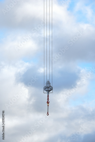 Crane hook hanging over an empty sky suspended in mid air