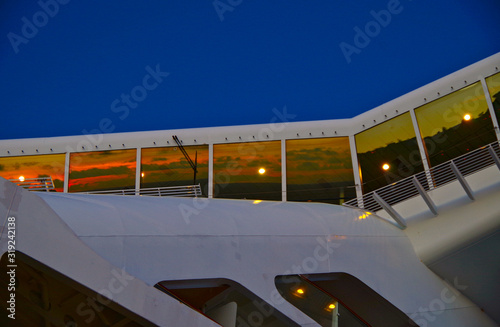 Navigational bridge, bow and superstructure detail view close up of modern Celebrity Cruises cruiseship or cruise ship liner during sunset or dawn photo