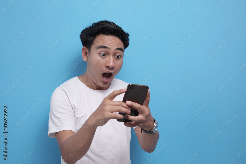 Shocked Happy Man Looking at Smart Phone Shocked Happy Man Looking at Smart Phone