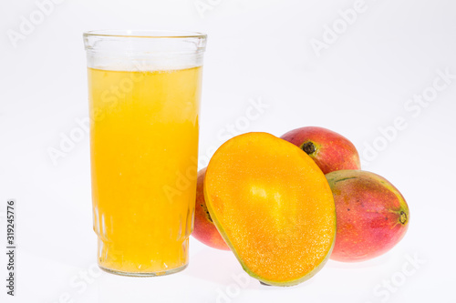 Mangoes with mango juice in a glass vase on white background.