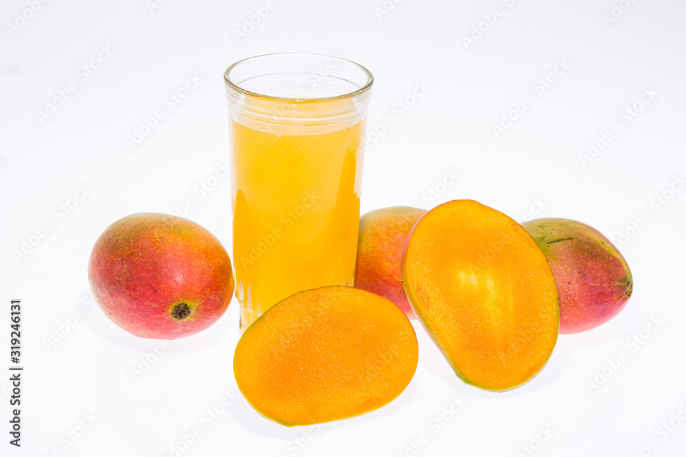 Mangoes with mango juice in a glass vase on white background. Mangoes with mango juice in a glass vase on white background.