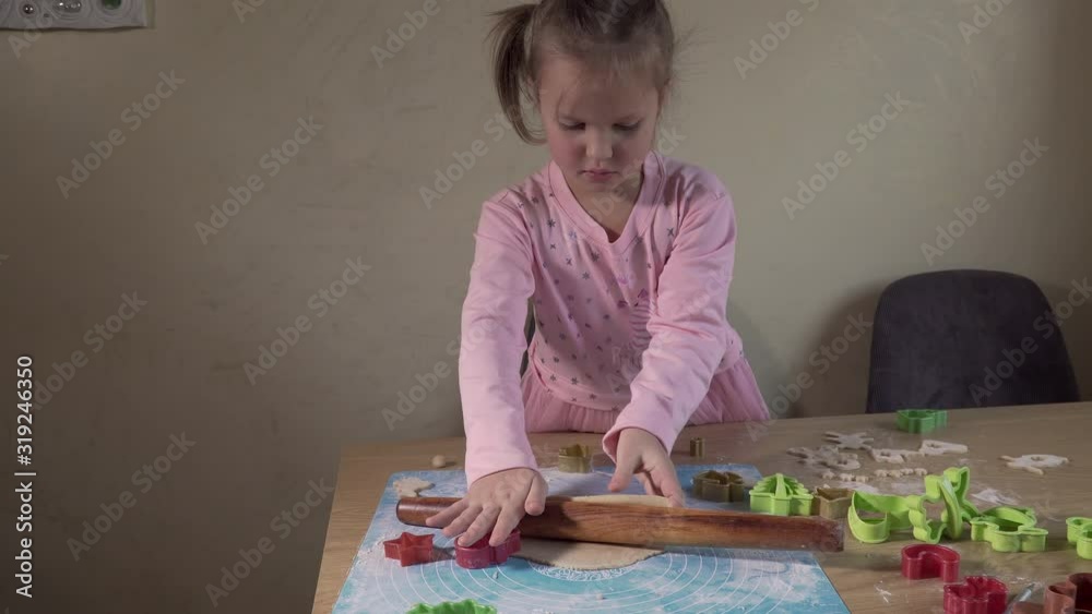 Female child rolls dough with rolling pin for Christmas cookies. 4K Female child rolls dough with rolling pin for Christmas cookies. 4K
