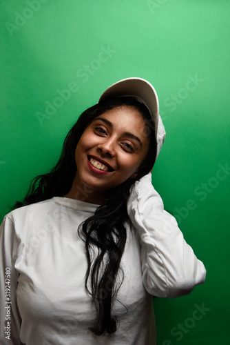 Young egyptian woman wearing white shirt with happy face expression.