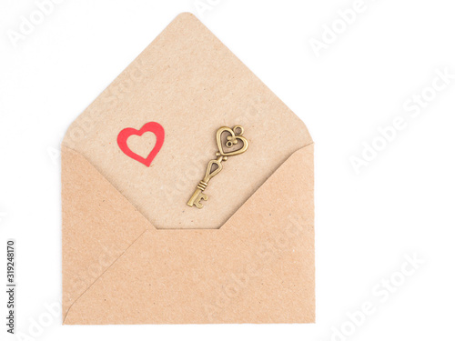 Image of a heart and a vintage key on a craft envelope isolated on a white