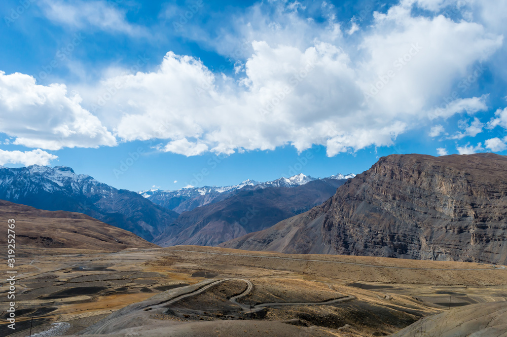 Arable land arabilis farmland meadows for mowing or pasture after harvest. Rice paddy Field agriculture farm after harvesting. Agricultural field in hill mountain with blue sky background. Spiti India Arable land arabilis farmland meadows for mowing or pasture after harvest. Rice paddy Field agriculture farm after harvesting. Agricultural field in hill mountain with blue sky background. Spiti India