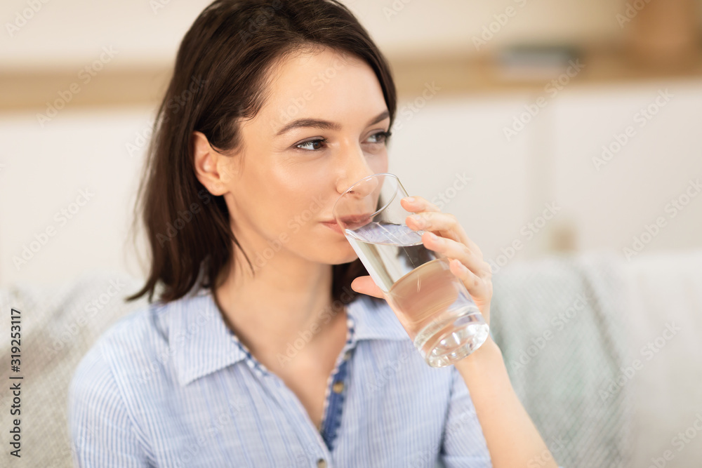 Smiling girl drinking clean water from glass Smiling girl drinking clean water from glass