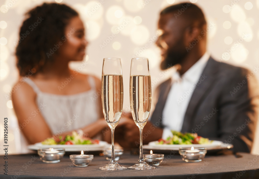 Two glasses of champagne on festive dinner table Two glasses of champagne on festive dinner table