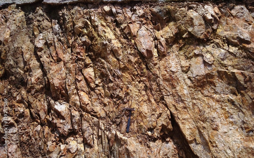 Rocks outcrop with geology hammer Rocks outcrop with geology hammer