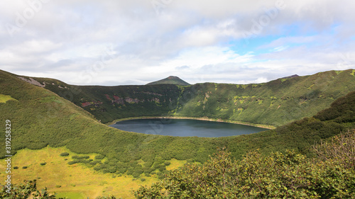 Small round lake inside the crater of the extinct volcano. Kamchatka Peninsula, Russia