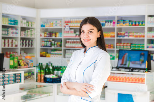 smart and confident woman pharmacist smiling. the face of the drug store