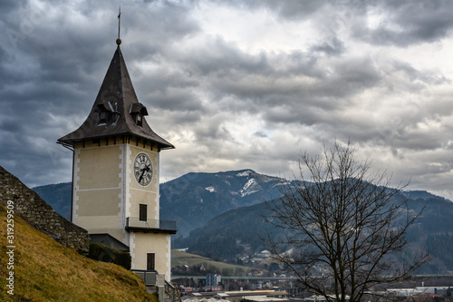 the clocktower of "Bruck an der Mur" city in Styria, Austria on a cloudy winter day
