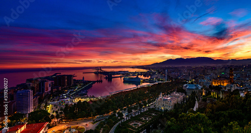 Obraz na płótnie a dramatic, colorful sky above Malaga w salonie