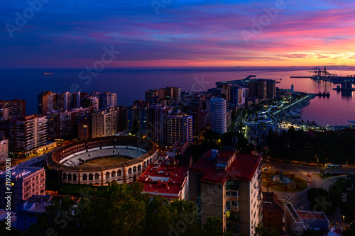 Obraz na płótnie a dramatic, colorful sky above Malaga w salonie
