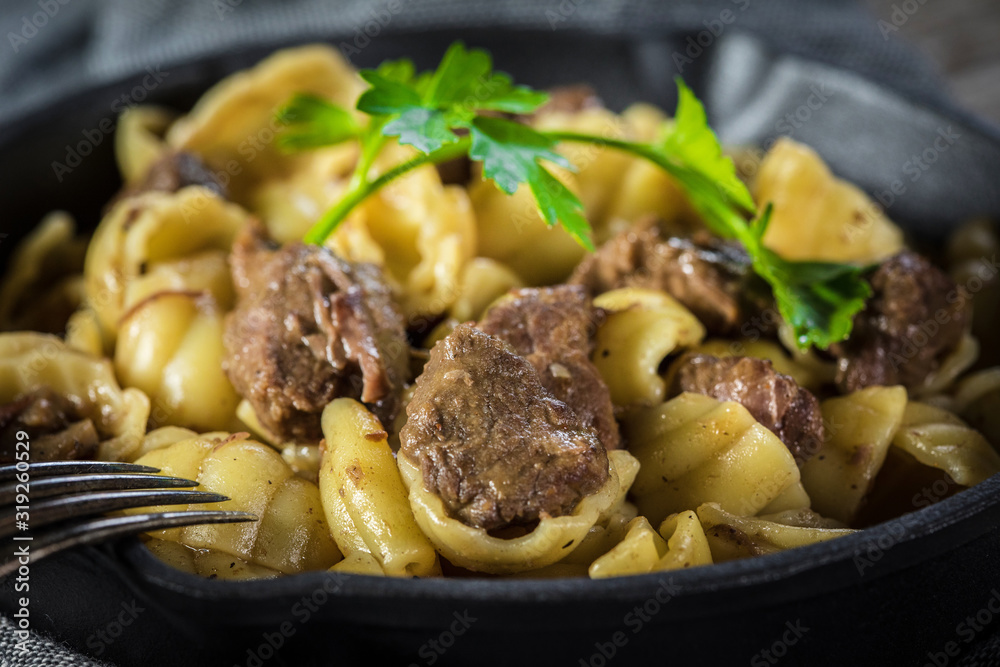 Italian pasta shells with beef sauce in cast iron pan. Italian pasta shells with beef sauce in cast iron pan.