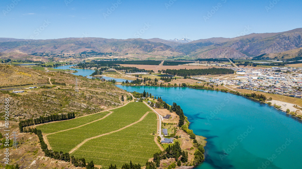 Turquoise river with a green fields and town Turquoise river with a green fields and town