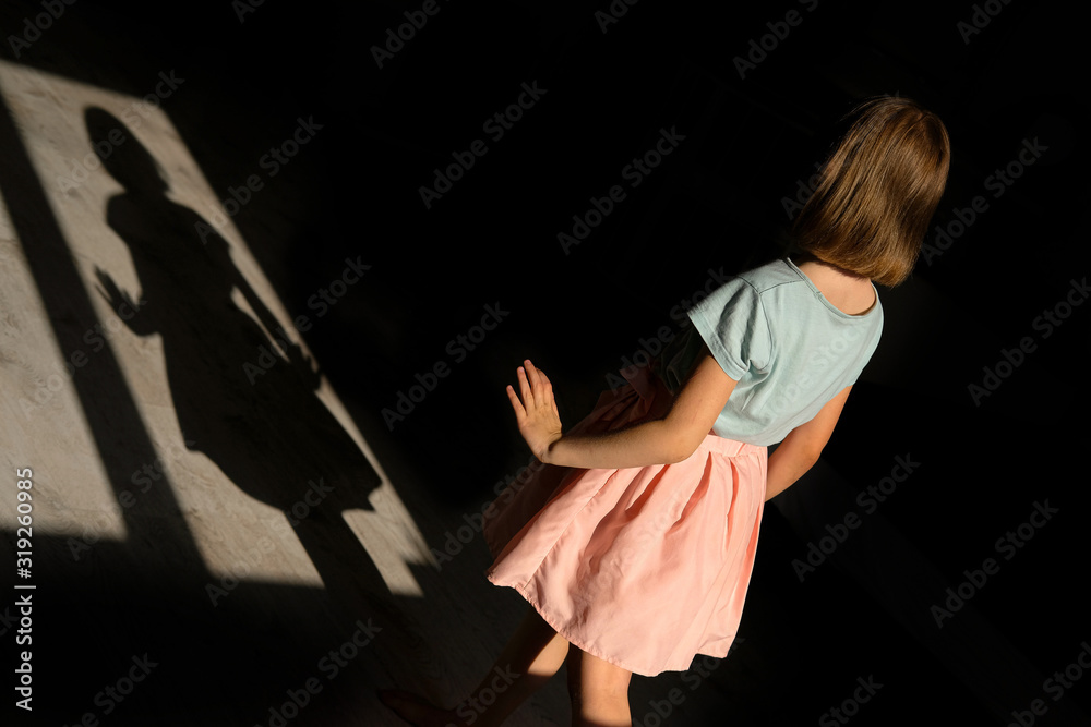 girl in beautiful and delicate clothes dancing. dance ballerina in a pink skirt. Game with a shadow. silhouette of a little princess girl in beautiful and delicate clothes dancing. dance ballerina in a pink skirt. Game with a shadow. silhouette of a little princess