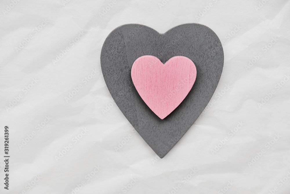 One big gray heart and inside it another pink heart in the middle of the photo. Photo taken by a flat lay. One big gray heart and inside it another pink heart in the middle of the photo. Photo taken by a flat lay.
