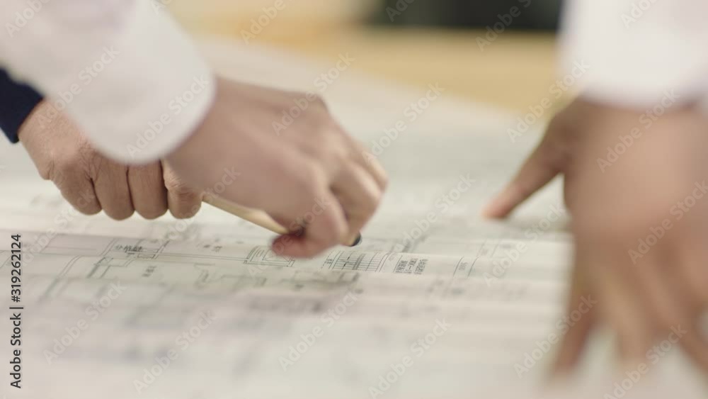 close-up of hands on blueprint when business team discussing in meeting close-up of hands on blueprint when business team discussing in meeting