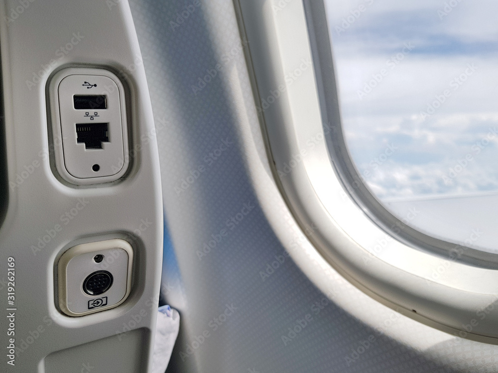 USB and LAN port, socket or outlet at back of the seat on airplane flight service for passengers. Closeup of USB and Land Socket. USB and LAN port, socket or outlet at back of the seat on airplane flight service for passengers. Closeup of USB and Land Socket.