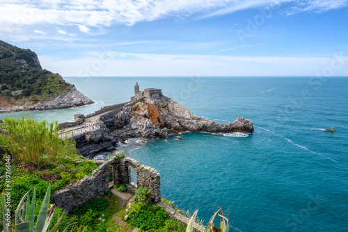 Beautiful aerial view with the Church of St. Peter (Chiesa di San Pietro) at the rocky coastline of Portovenere, Italy.