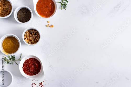 Set of different spices for sauces on stone background.