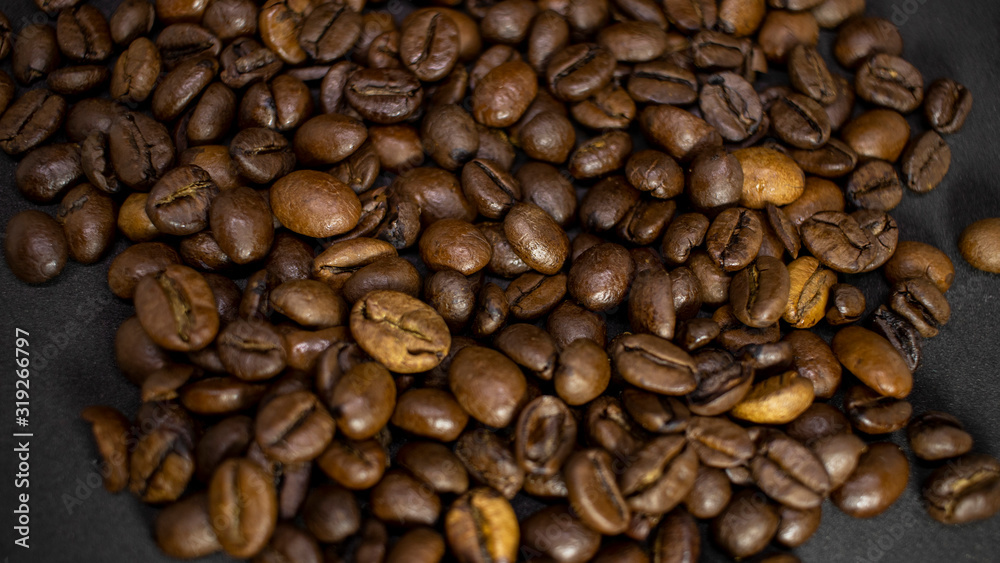 Dark background and texture of coffee beans, selective focus, closeup grains. Dark background and texture of coffee beans, selective focus, closeup grains.