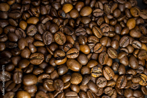 Dark background and texture of coffee beans, selective focus, closeup grains.