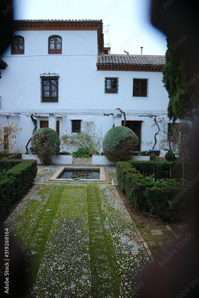 View of Paraiso gardens in Alhambra, Granada, Spain in the winter morning haze