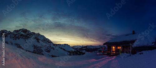 Fotografie Evening mood in a lonely mountain hut in the Austrian Alps, summit of the Breith