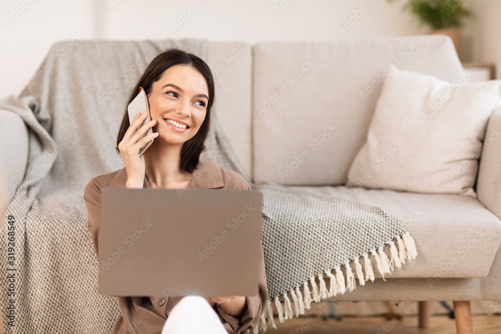 Young woman talking on cellphone sitting on the floor Young woman talking on cellphone sitting on the floor