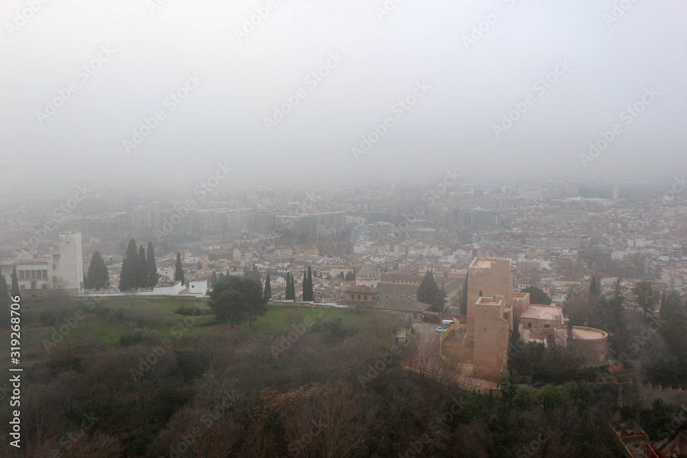 aerial view of the city Granada in the mroning fog from Alhambra citadel