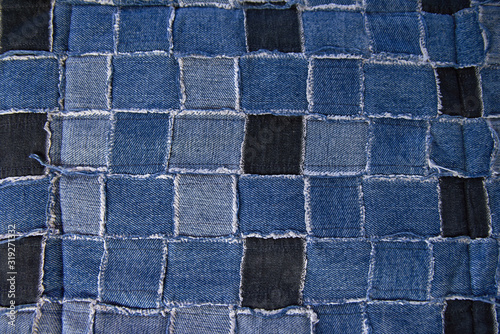 Tiny vintage fabric pieces sewn together into a patchwork for a quilt top. blue background texture