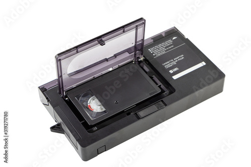 Video cassette adapter S/VHS with compact cassette (VHSC) inside. Isolated on white background.